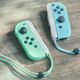 a photo of the animal crossing new horizons joy cons against a wooden background
